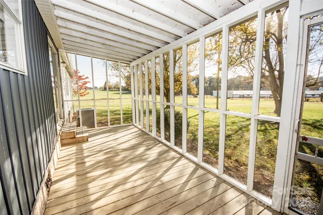 a view of a room with wooden floor and windows