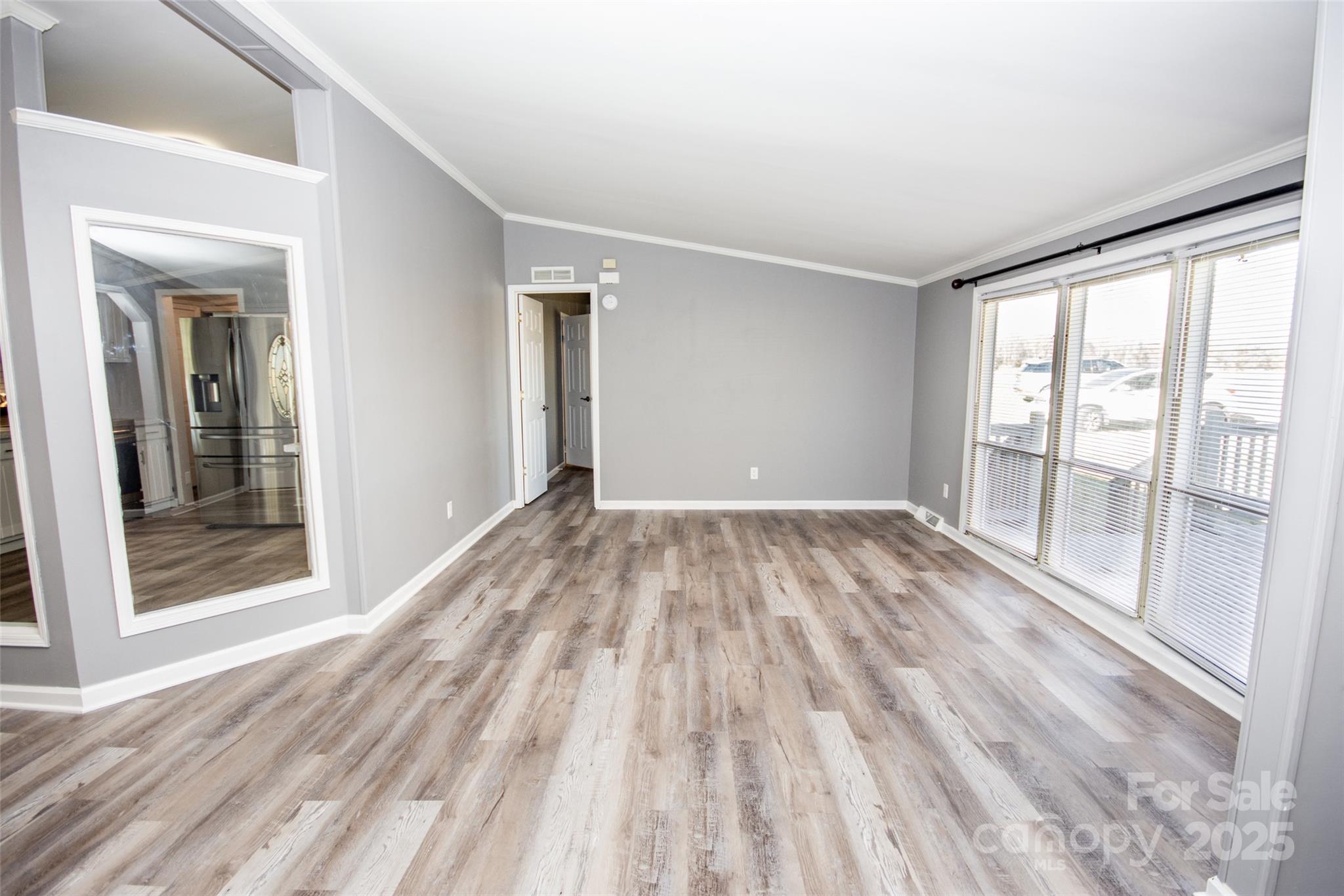 943 Tabor Road Olin, NC 28660 - Photo 5 of 31 wooden floor in an empty room with a window