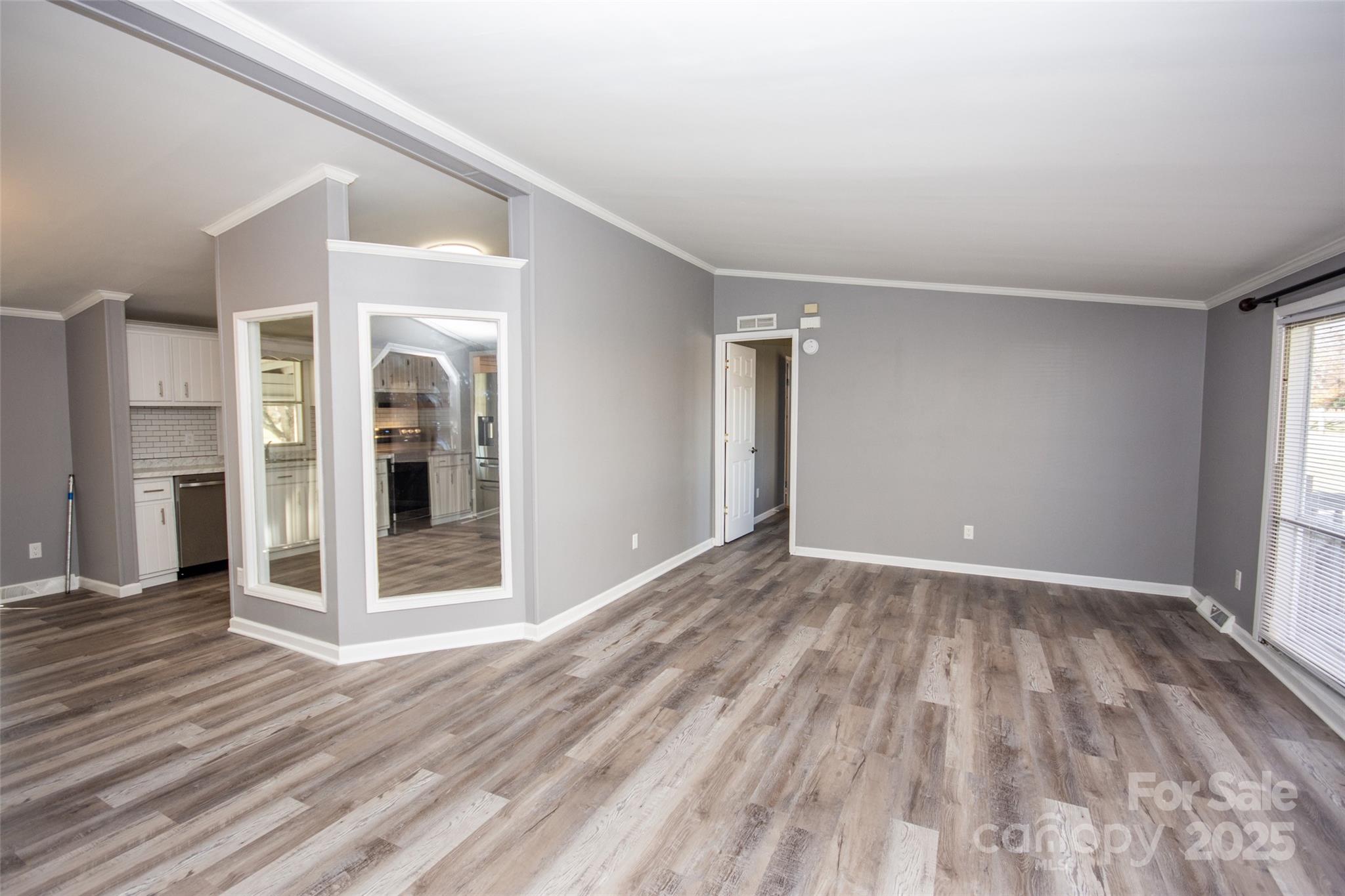 943 Tabor Road Olin, NC 28660 - Photo 6 of 31 a view of an empty room with wooden floor and a window