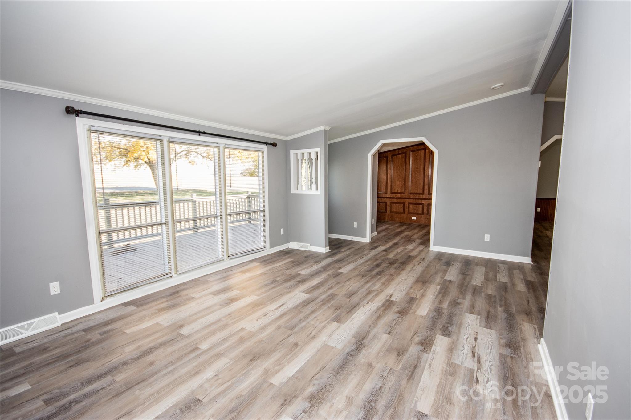 943 Tabor Road Olin, NC 28660 - Photo 7 of 31 a view of empty room with wooden floor and fan