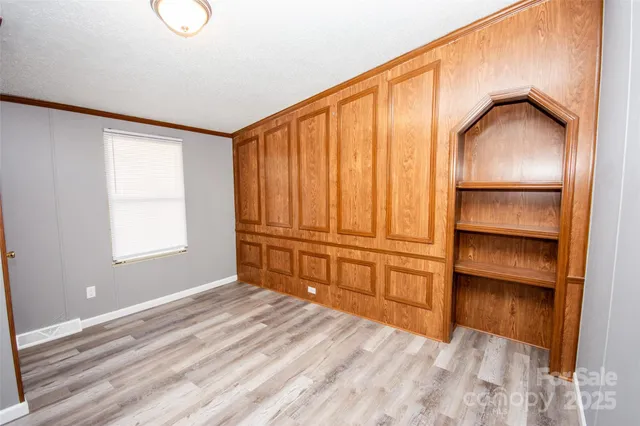 a view of a room with wooden floor and cabinet