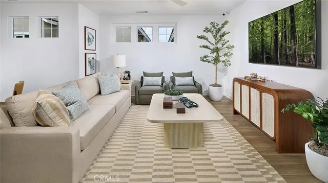 a living room with furniture floor to ceiling window and potted plant