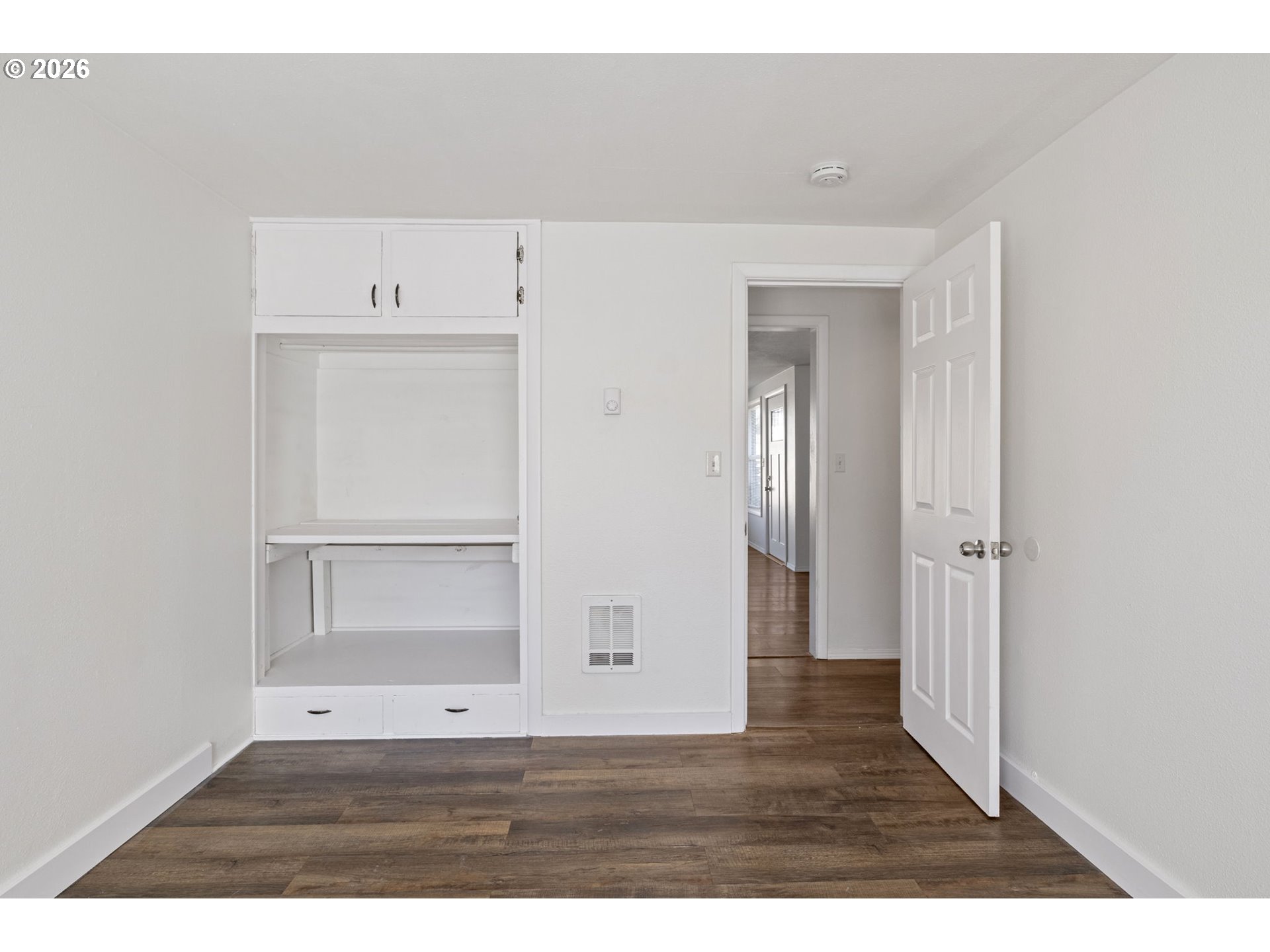 1008 Coburg Road Eugene, OR 97401 - Photo 15 of 46 a view of an empty room with closet and wooden floor