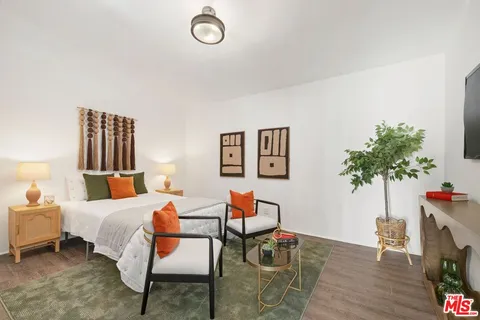 a bedroom with furniture and a potted plant