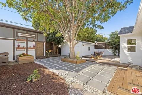 a view of a backyard with large trees