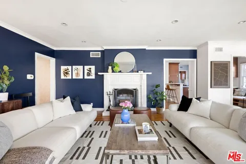 a living room with furniture fireplace and window
