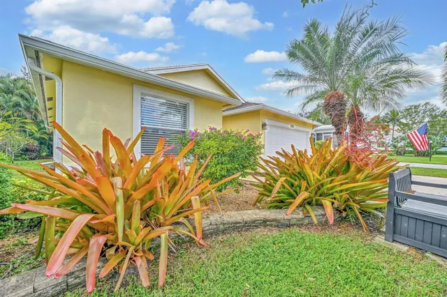a living room with patio furniture and a floor to ceiling window