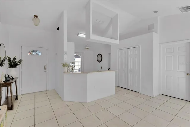 a view of kitchen with furniture and a refrigerator