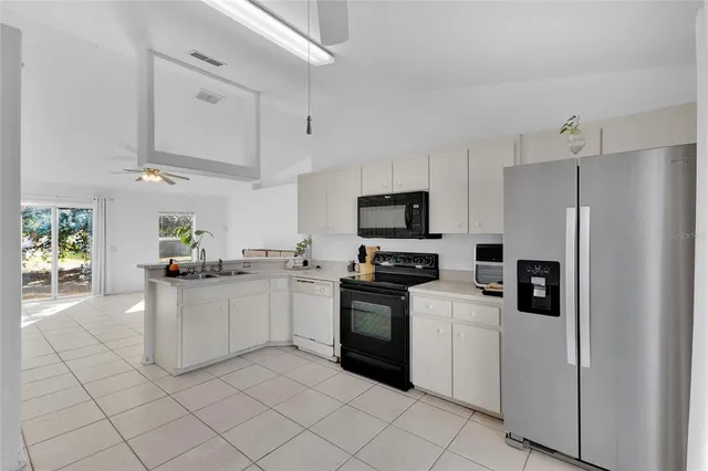 a kitchen with stainless steel appliances a stove refrigerator sink and microwave