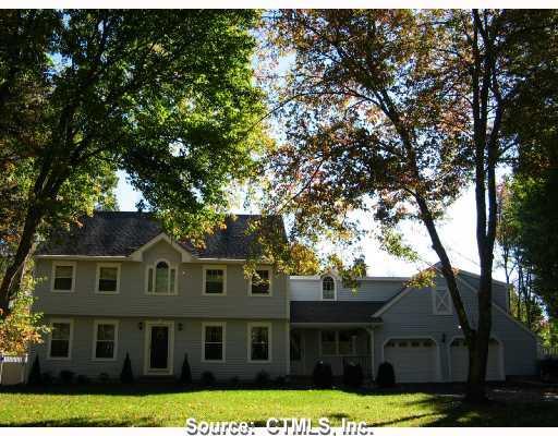 a front view of a house with yard and green space