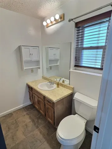 a bathroom with a stove a sink and a window