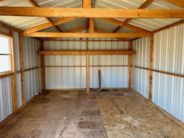 a view of backyard with wooden fence