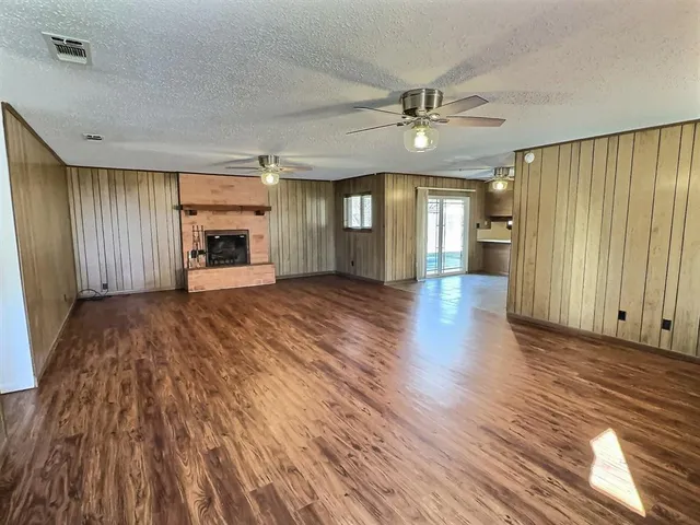 wooden floor in an empty room with a fireplace