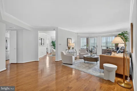 a living room with fireplace furniture and a wooden floor