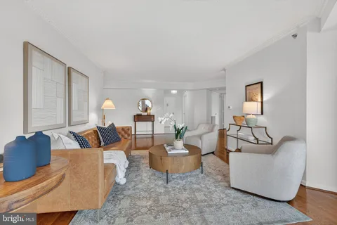 a kitchen with stainless steel appliances granite countertop a sink dishwasher stove and white cabinets with wooden floor