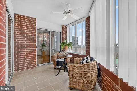 a dining room with furniture and a potted plant