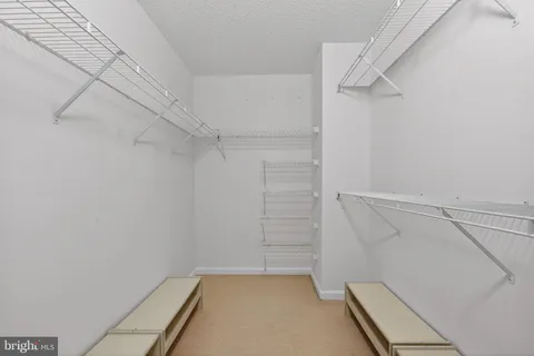 a bedroom with a bed window and couch