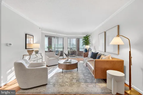a living room with furniture a lamp a rug and a window