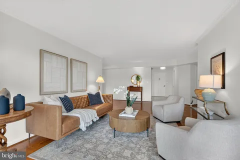 a living room with furniture and a lamp