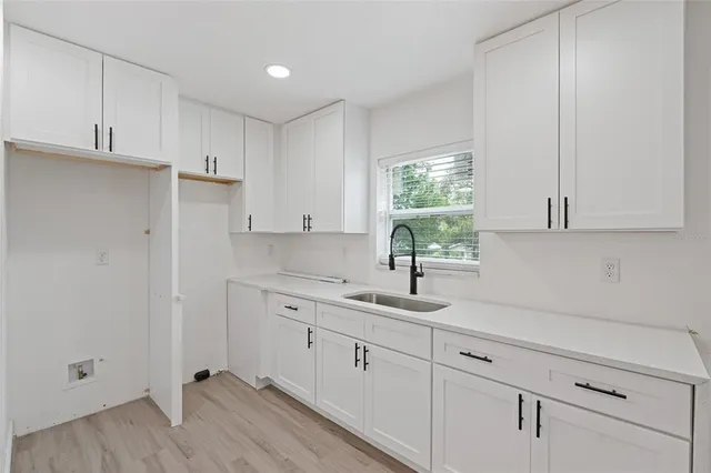 a kitchen with appliances cabinets and a window
