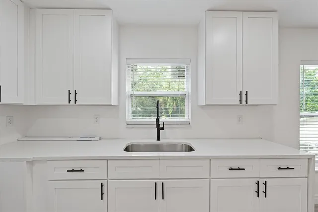 a view of empty room with wooden floor and ceiling fan