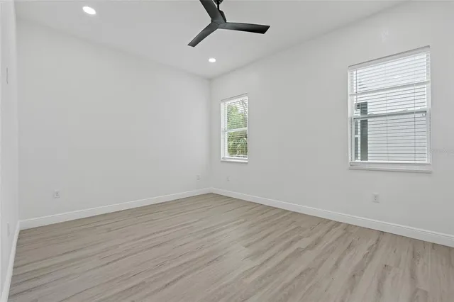 wooden floor in an empty room with a window