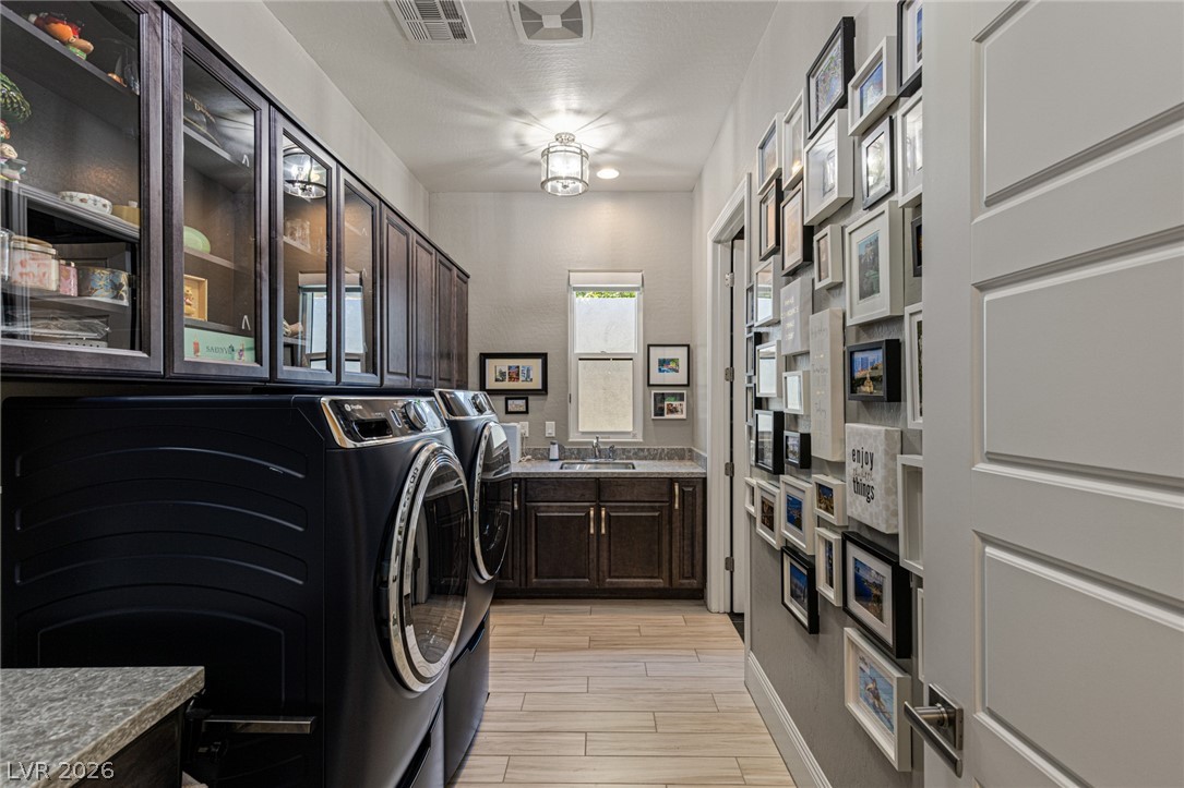 10118 Copper Edge Road Las Vegas, NV 89148 - Photo 28 of 48 Functional utility room offering ample storage, integrated sink, and convenient laundry facilities.