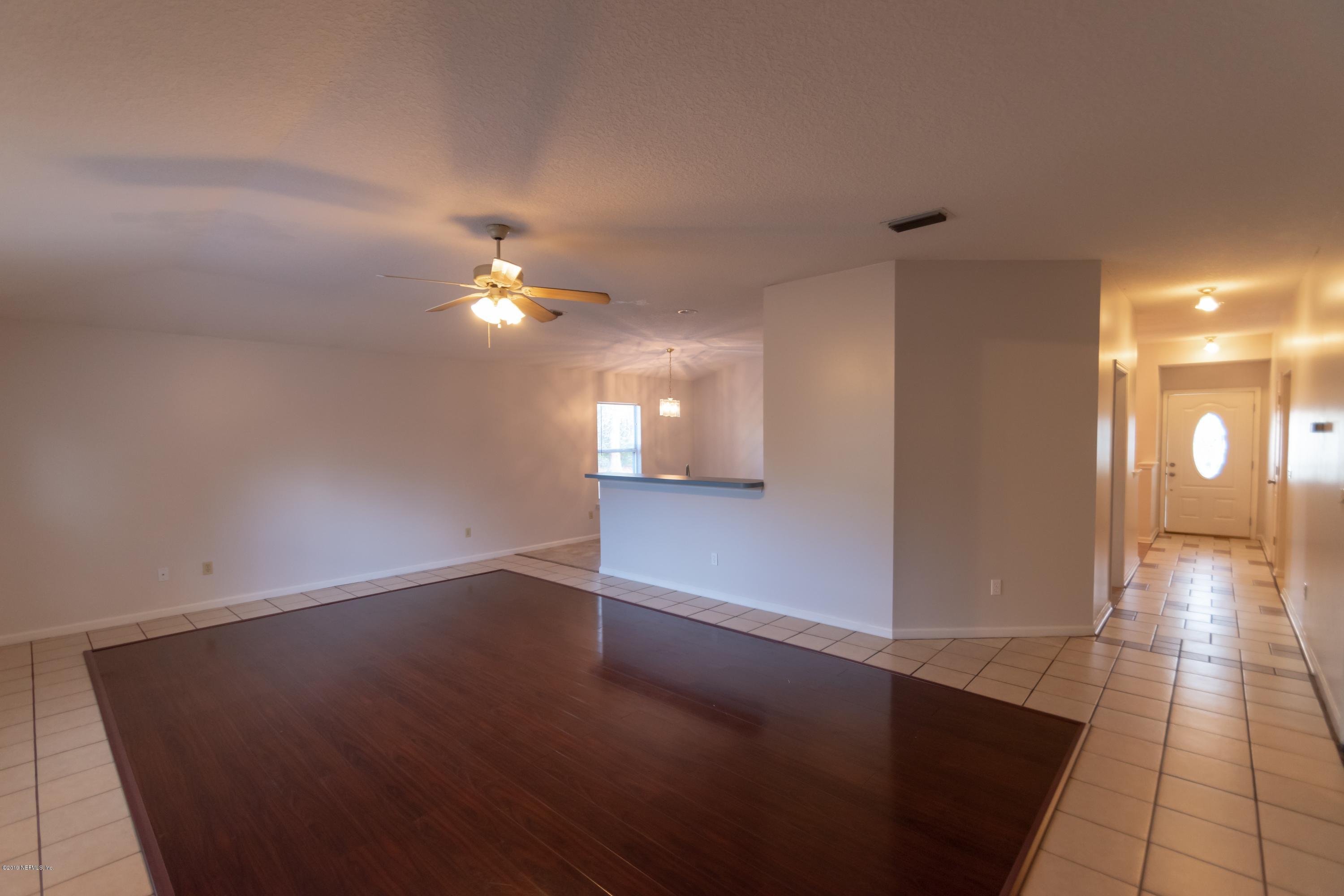 11367 Old Gainesville Road Jacksonville, FL 32221 - Photo 20 of 54 an empty room with wooden floor and windows