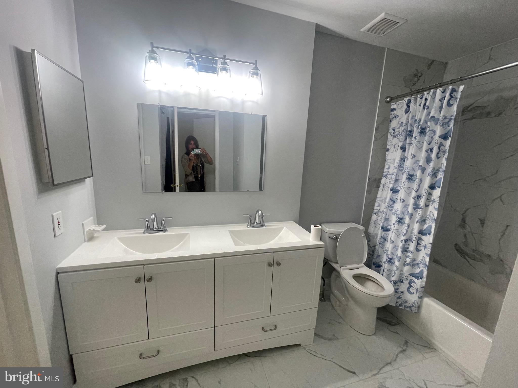 2123 Rhododendron Court Mays Landing, NJ 08330 - Photo 12 of 27 a bathroom with a double vanity sink mirror and toilet