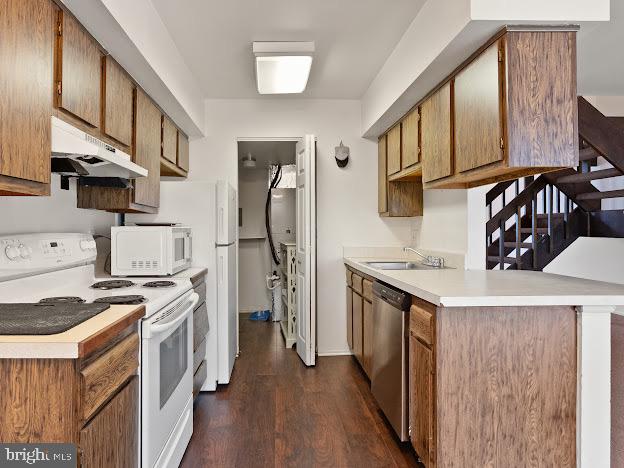 2123 Rhododendron Court Mays Landing, NJ 08330 - Photo 17 of 27 a kitchen with stainless steel appliances granite countertop a stove top oven a refrigerator a sink and dishwasher with wooden floors