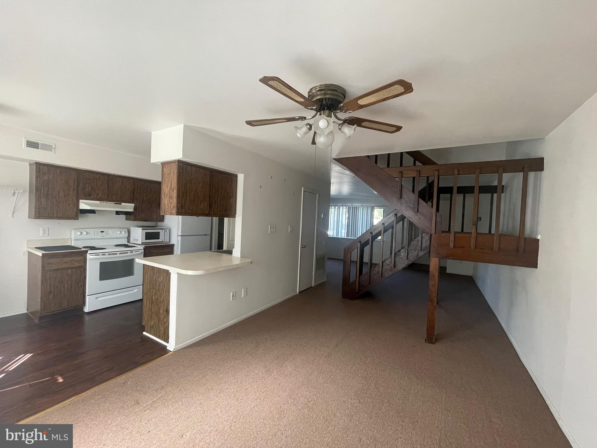 2123 Rhododendron Court Mays Landing, NJ 08330 - Photo 6 of 27 a kitchen with white cabinets and white appliances
