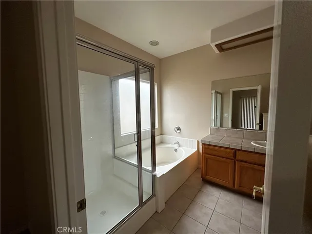 an empty room with closet and a chandelier fan