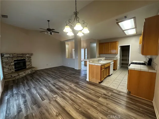 a open kitchen with a stove a sink and a refrigerator