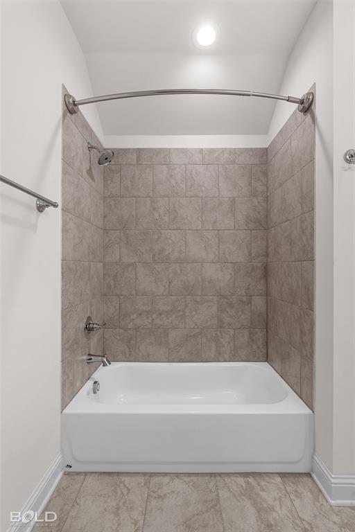 304 Prien Lk Loop Bossier City, LA 71111 - Photo 31 of 39 Full bathtub with a tiled shower surround, chrome fixtures, and a curved shower rod