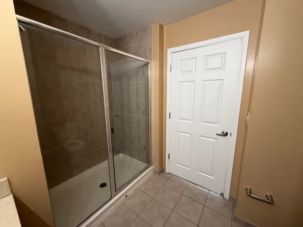 a bathroom with a glass shower door