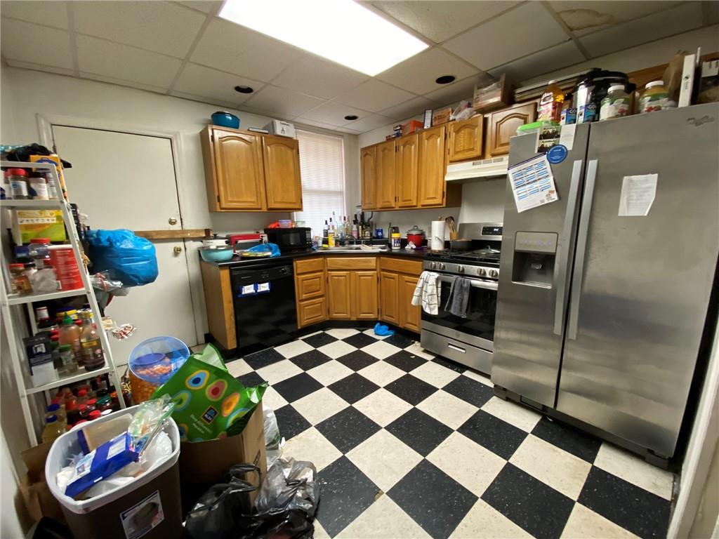 3306 Ward Street Pittsburgh, PA 15213 - Photo 2 of 12 a kitchen with stainless steel appliances granite countertop a sink and a refrigerator