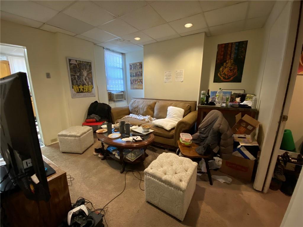 3306 Ward Street Pittsburgh, PA 15213 - Photo 3 of 12 a living room with furniture gym equipment and a flat screen tv