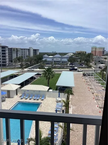 a view of a swimming pool with furniture
