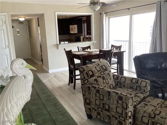 a view of a dining room with furniture and a large window