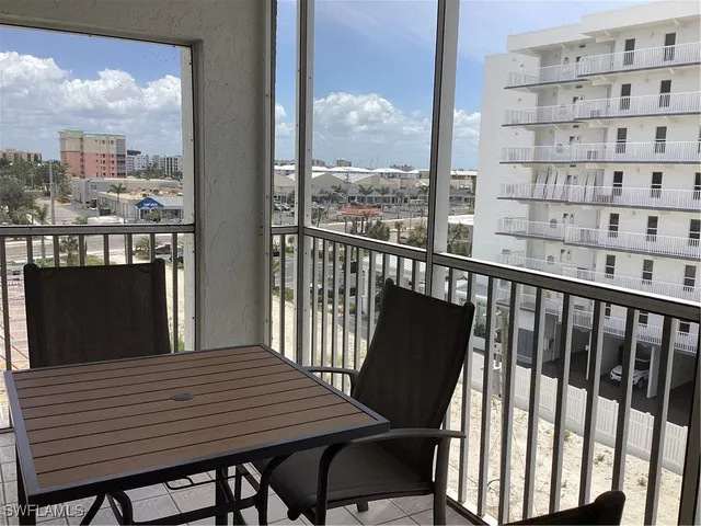 a view of a balcony with a table and chairs