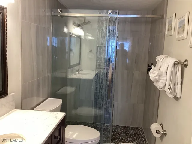 a bathroom with a sink toilet and shower