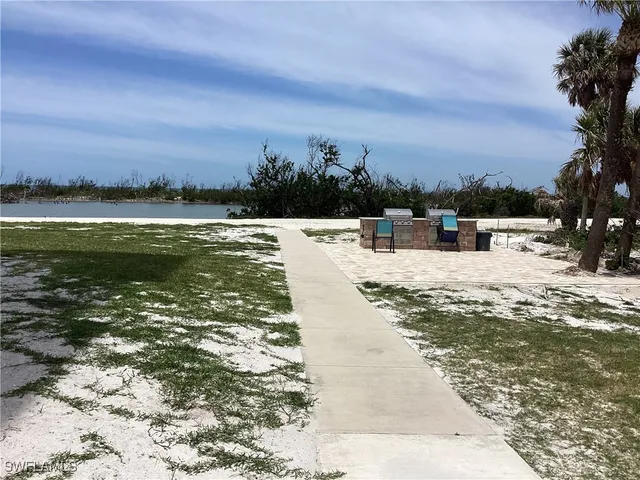 a view of swimming pool with outdoor seating and yard in back