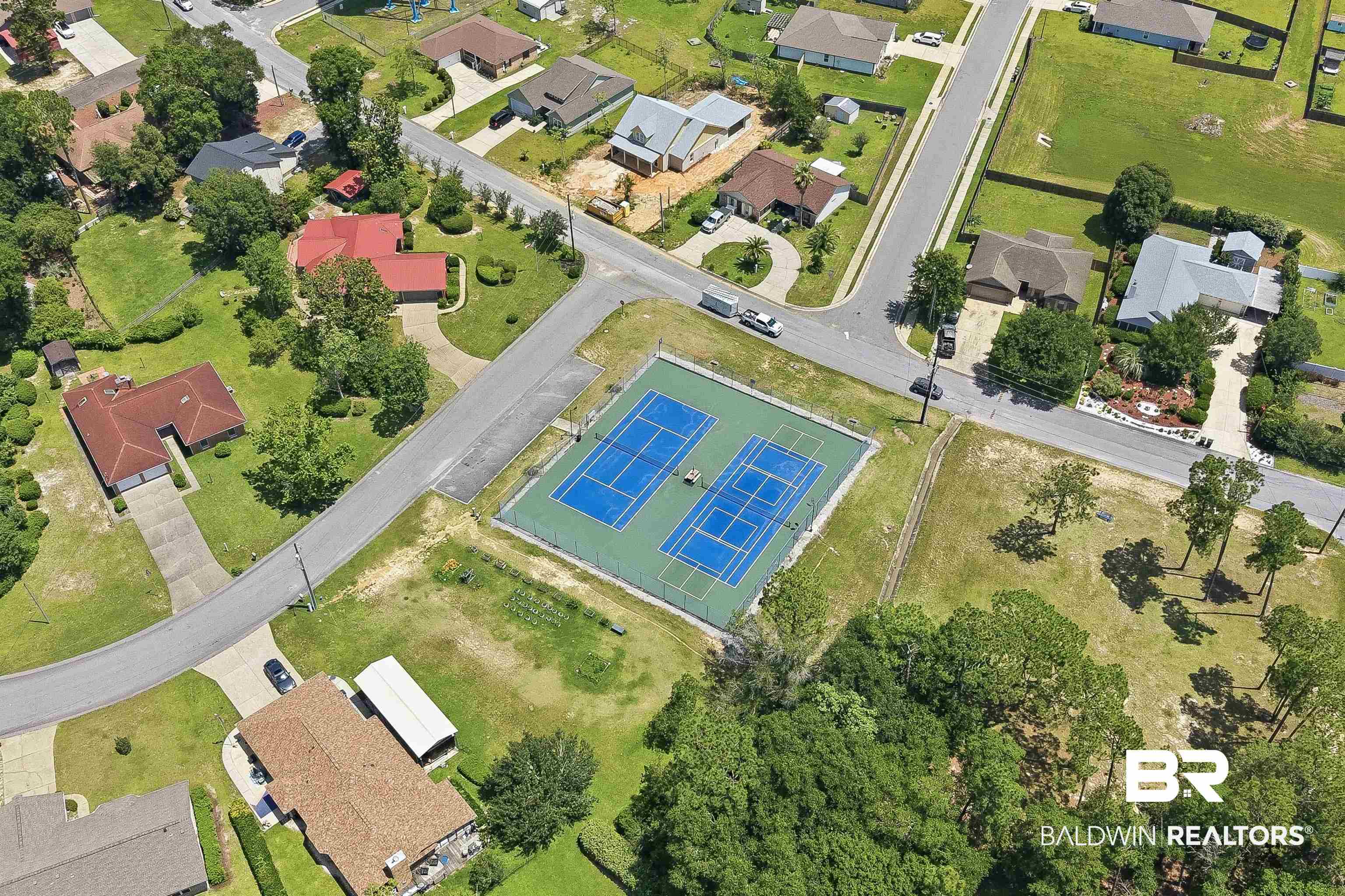 3213 Camino Real Loop Lillian, AL 36549 - Photo 16 of 61 Aerial perspective showcasing a residential community with paved roads and mature trees