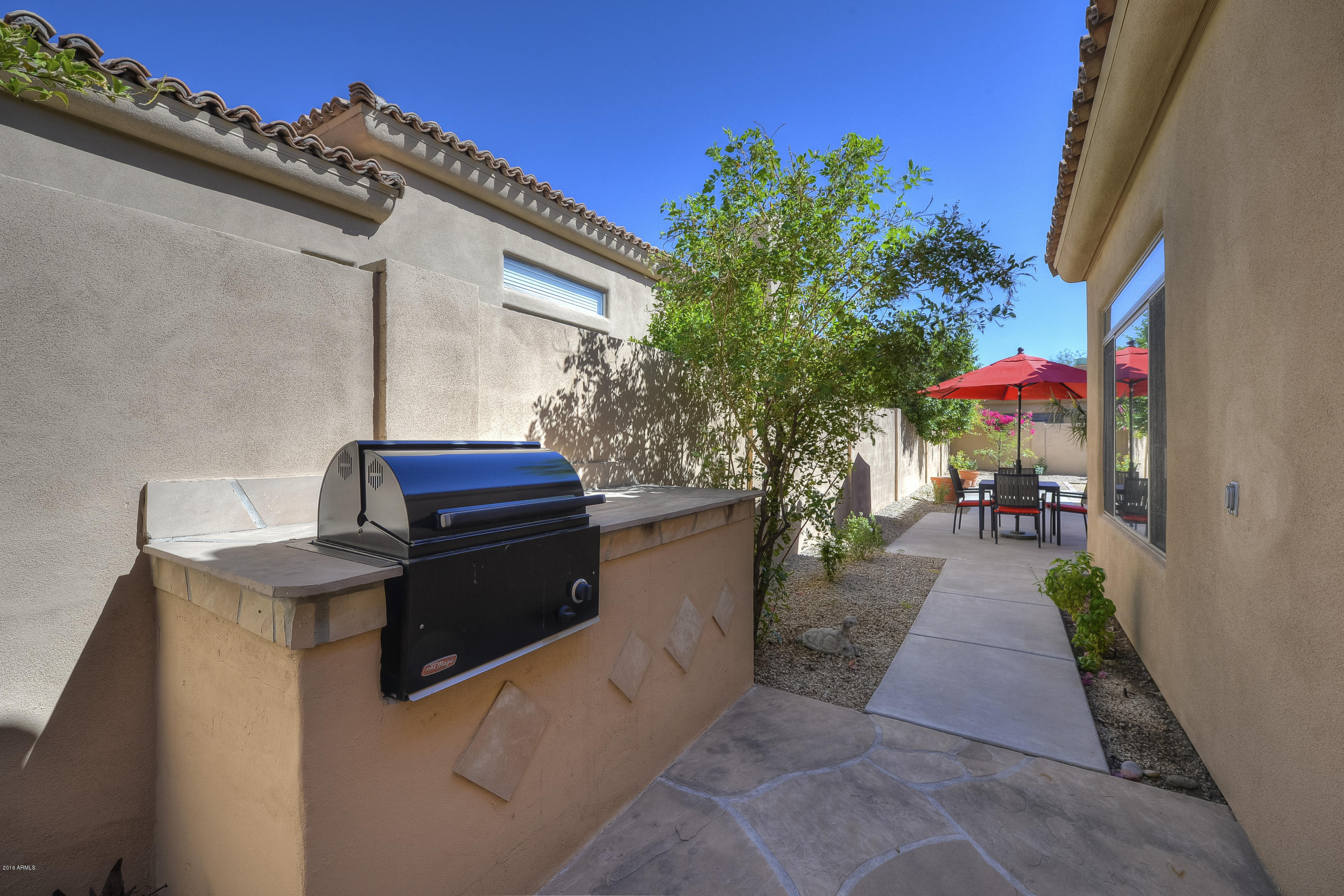 8147 East Beardsley Road Scottsdale, AZ 85255 - Photo 21 of 24 a view of a patio with table and chairs potted plants with wooden fence