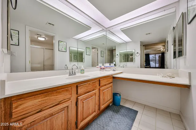 a spacious bathroom with a sink mirror and a bath tub
