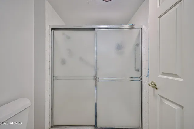 a bathroom with a glass shower door