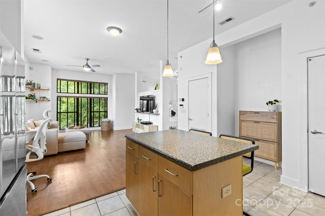 an open kitchen with granite countertop a stove and a sink