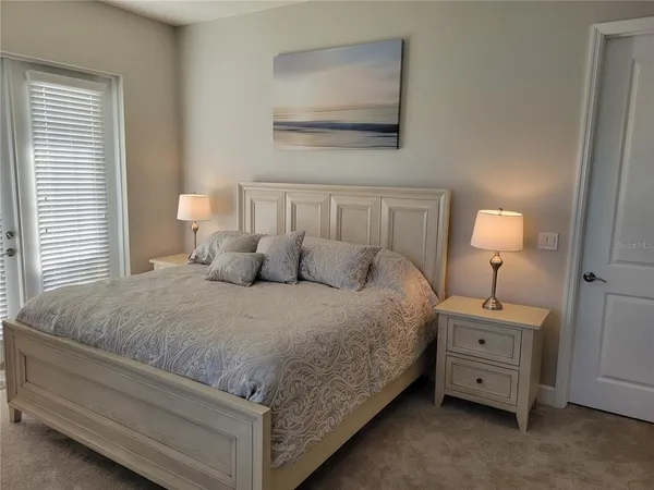 a bed room with a bed and a night stand