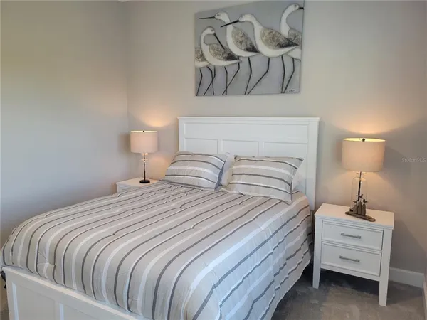 a bedroom with a bed and lamp