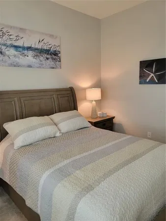 a bedroom with a bed and lamp